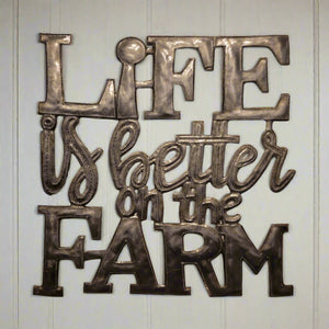 Decorative metal wall art with 'Life is better on the farm' text.